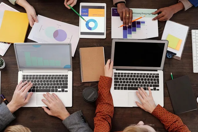 work meeting, notebook, charts, report, work desk, office, collaboration, ideas, discussion, planning, writing, teamwork, smart device, office tools, contemporary, business analysis, data, office paper, table. How to spot marketing agencies measurement mistakes without guesswork